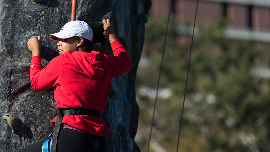 Student on rock-climbing wall