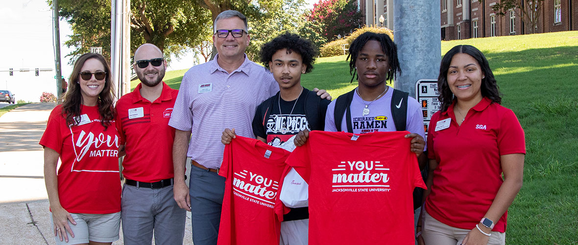 Terry Casey and students hold up You Matter tee shirts