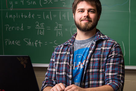 Math student in front of chalkboard