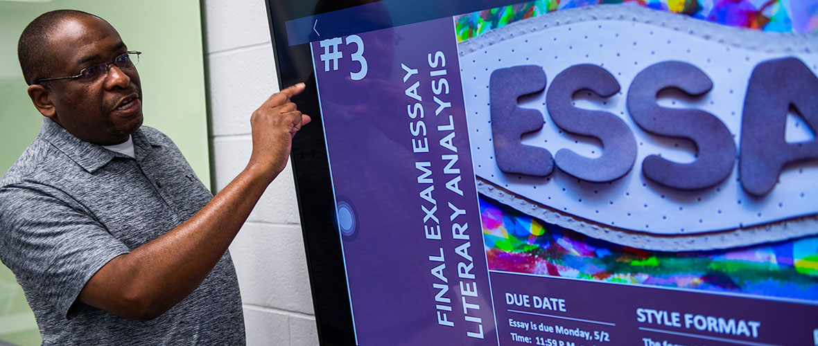 Mr. Rodney Bailey points to screen while teaching