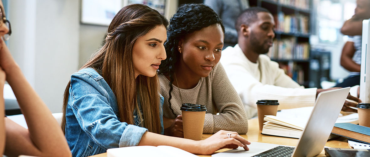 Two students working on a cyber security project at a computer