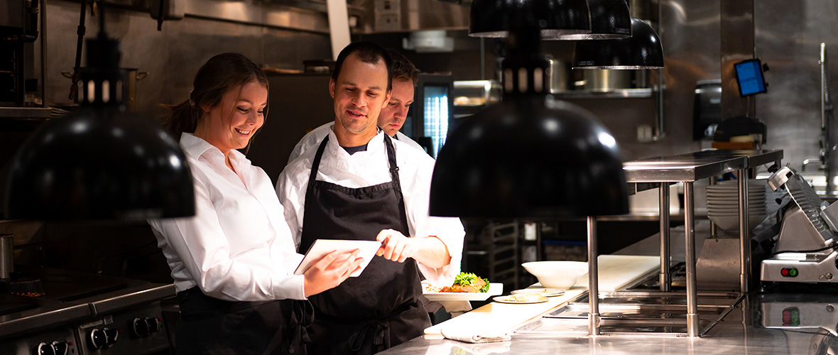 Employees in kitchen of restaurant