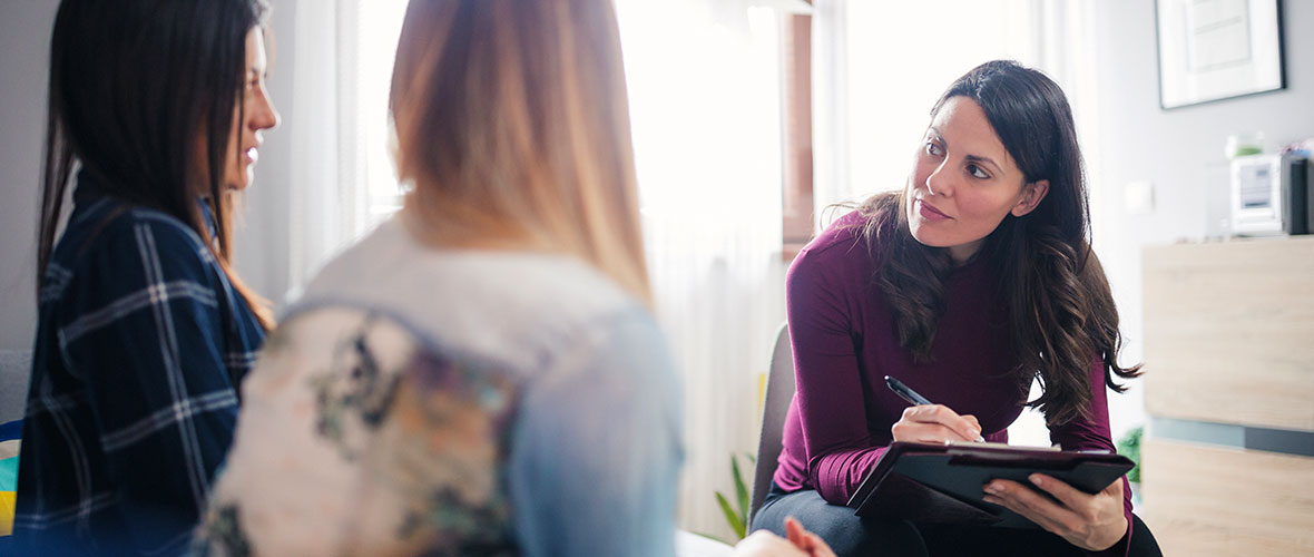 a public health worker conducts an interview with a client