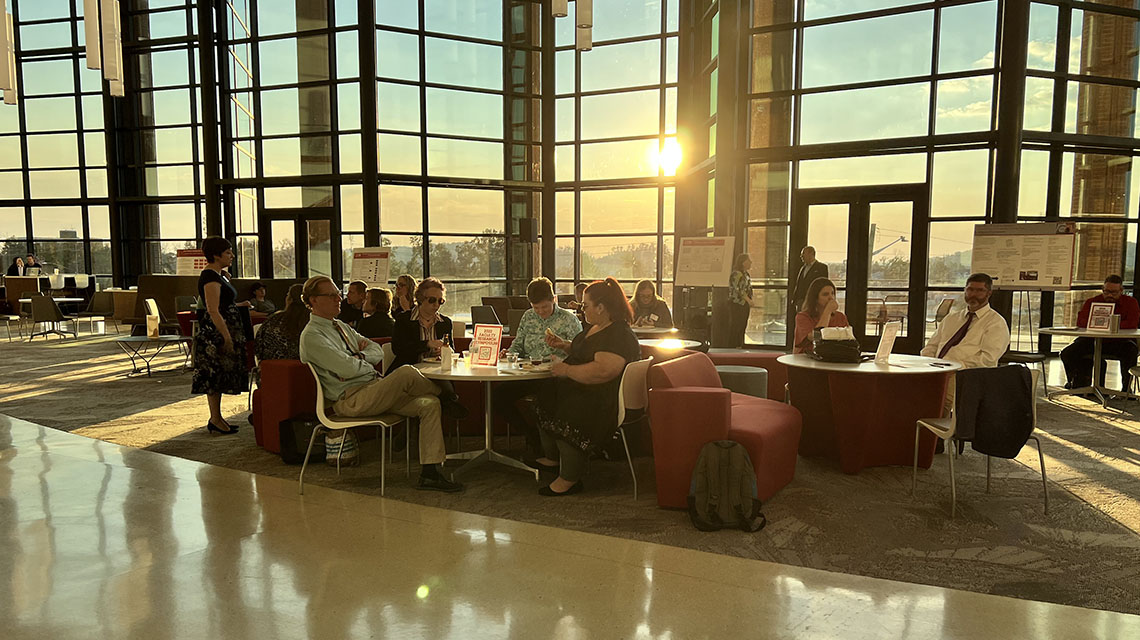 Attendees in the atrium of Merrill Hall